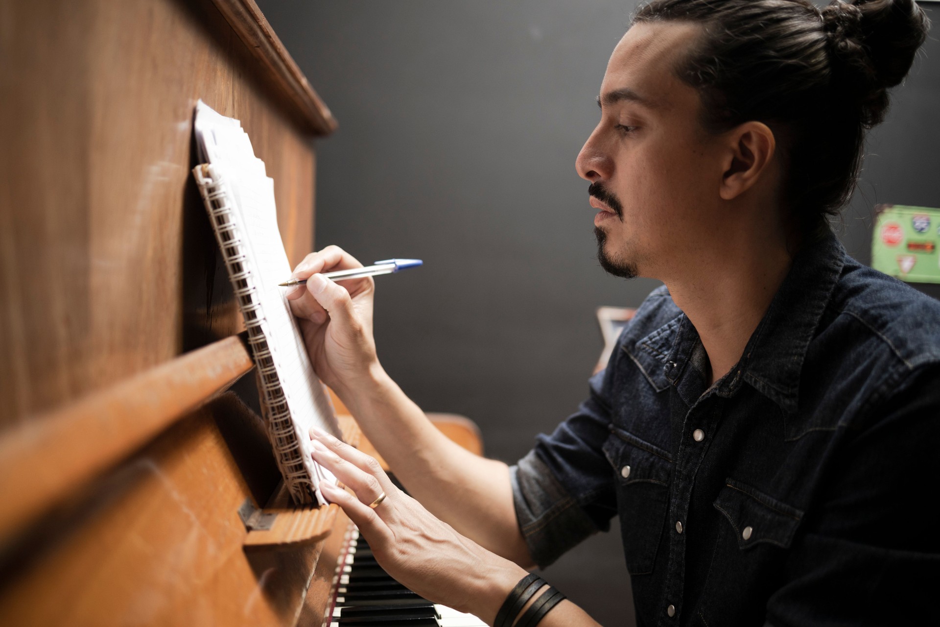 Man playing and composing at the piano