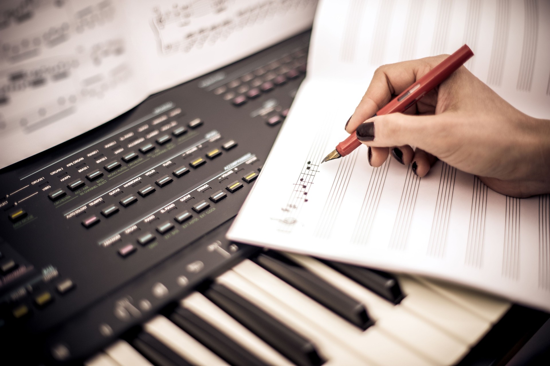 Young Woman Writing Musical Note While Playing Keyboard
