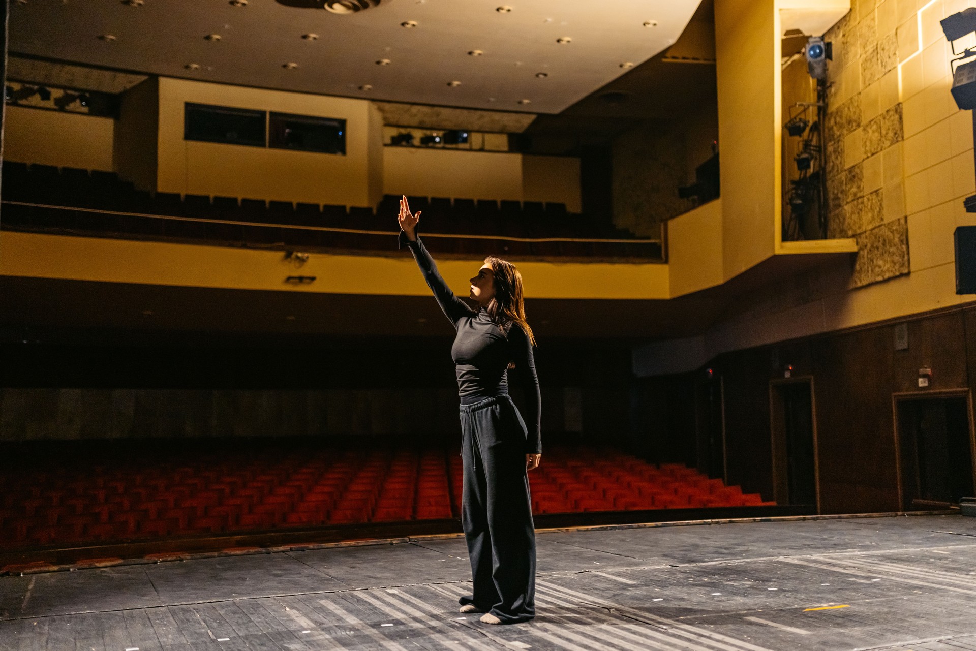 Young Woman Performing Interpretative Dance In An Empty Theatre